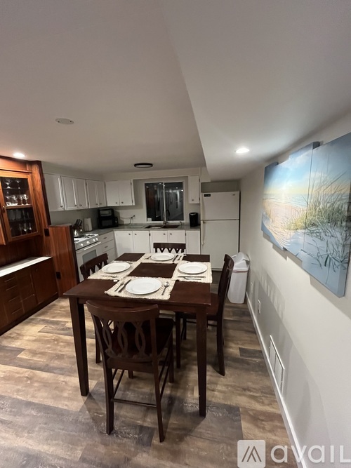 A kitchen with a dining table set for four.