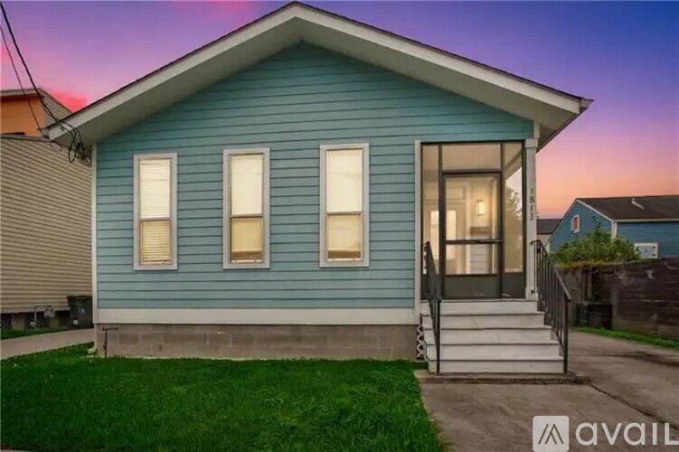 A blue house with a white door and windows is shown.