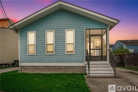 A blue house with a white door and windows is shown.