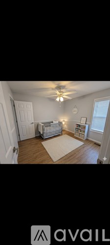 A living room with a couch and a ceiling fan.