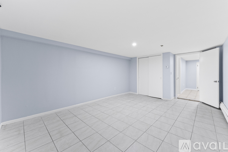 A spacious room with a tiled floor and white walls.