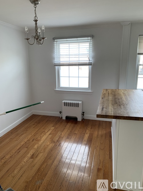A room with wooden floors and a chandelier.