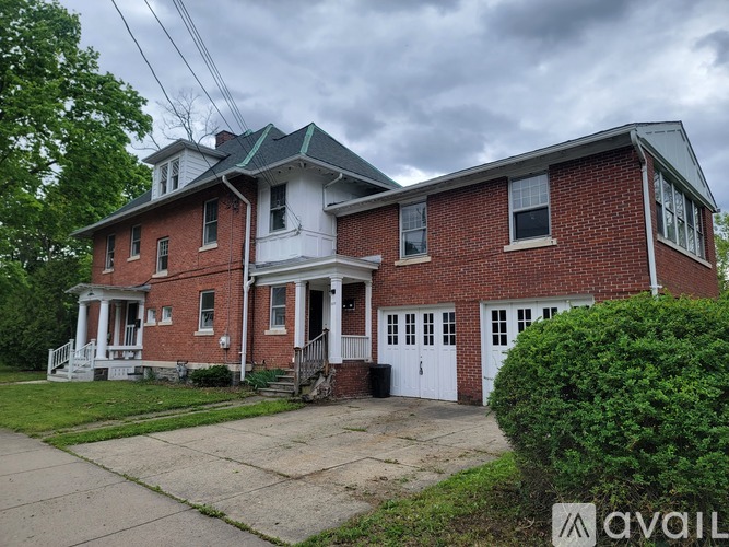 A two-story brick house with a white front porch.