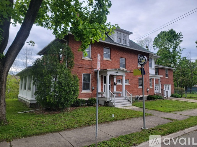 A brick house with a sign that says BC.