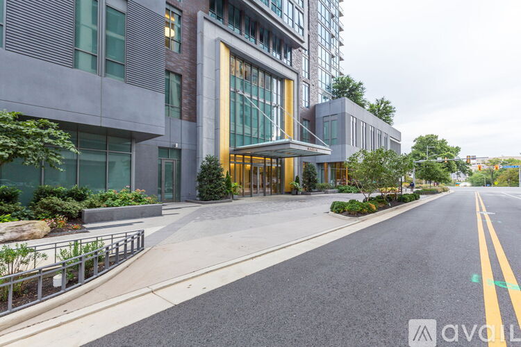 A street view of a modern building with a yellow line on the road.