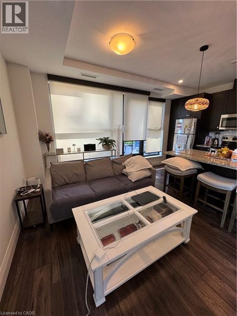 A modern living room with a grey couch and a white coffee table.