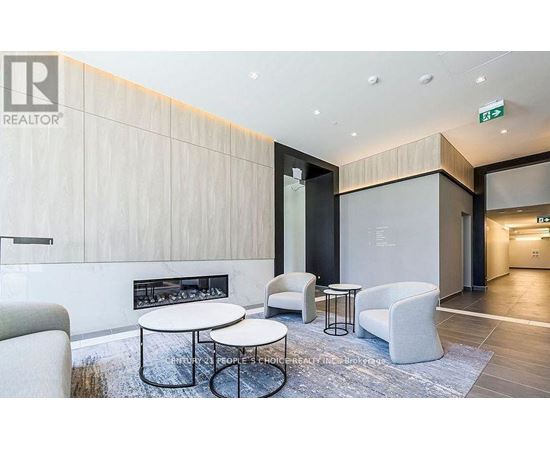 A modern waiting area with a fireplace and comfortable seating.