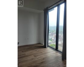 A room with a large window overlooking a cityscape.