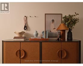 A shelf with books, a lamp, and a picture frame on it.