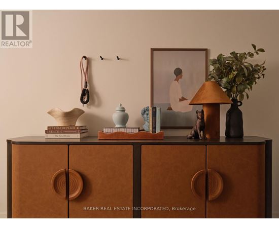 A shelf with books, a lamp, and a picture frame on it.