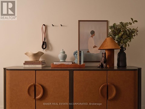 A shelf with books, a lamp, and a picture frame on it.