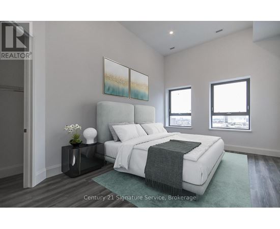 A bedroom with a large bed and a painting on the wall.