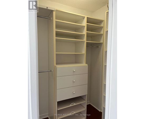 A white closet with shelves and drawers is shown.