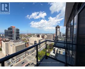 A cityscape viewed from a balcony with a sign that reads "REALTOR".