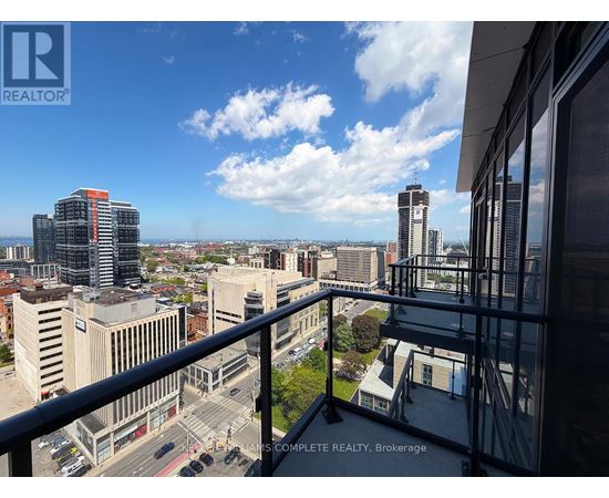 A cityscape viewed from a balcony with a sign that reads "REALTOR".