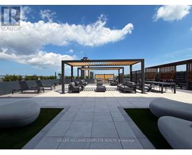 A modern outdoor seating area with a white and grey tiled floor and a wooden pergola.