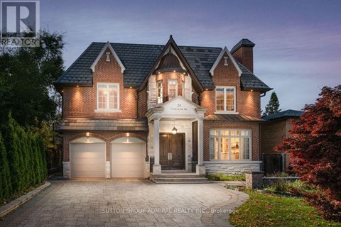 A large, two-story house with a brick facade and a large front yard.