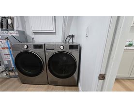Two front load washing machines are placed next to each other.