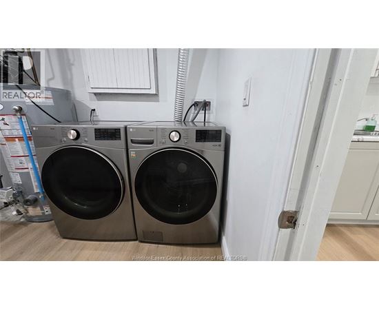 Two front load washing machines are placed next to each other.