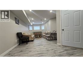 A living room with a couch, chair, and rug.