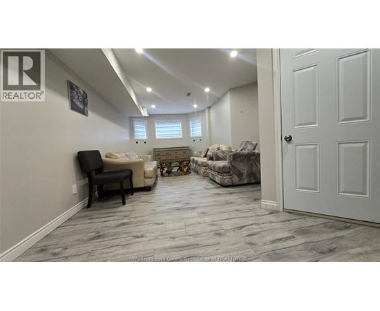 A living room with a couch, chair, and rug.