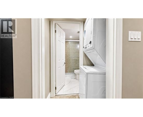 A white door is open to a bathroom with a walk-in shower.