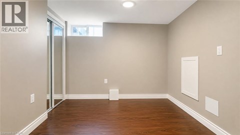 A room with a wooden floor and a sliding glass door.