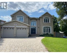 A house with a grey garage door is for sale.