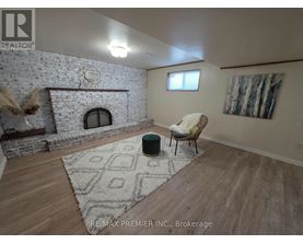 A living room with a fireplace and a chair.