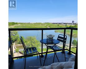 A balcony with a table and two chairs overlooking a river.