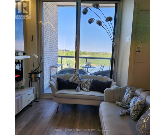A living room with a couch and a view of the outside.