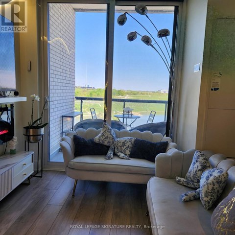 A living room with a couch and a view of the outside.