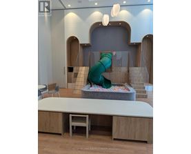 A slide in a play area with a green cover.