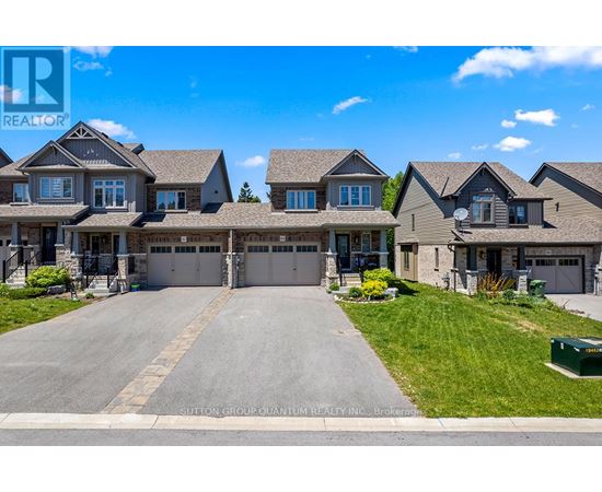 A large, well-maintained house with a driveway in front is for sale.