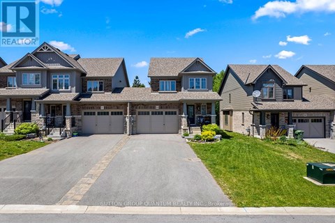 A large, well-maintained house with a driveway in front is for sale.