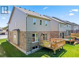 A house with a deck in front of it.