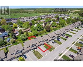 A bird's eye view of a residential area with a red line indicating a boundary.