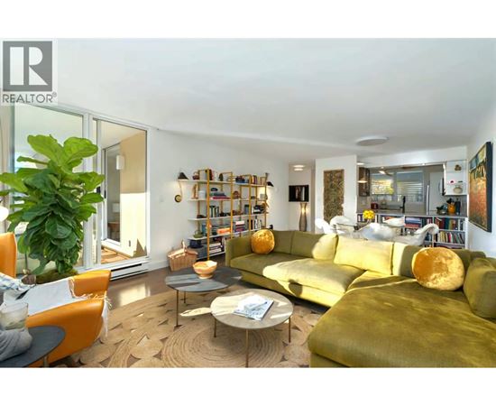A living room with a green couch and a coffee table.