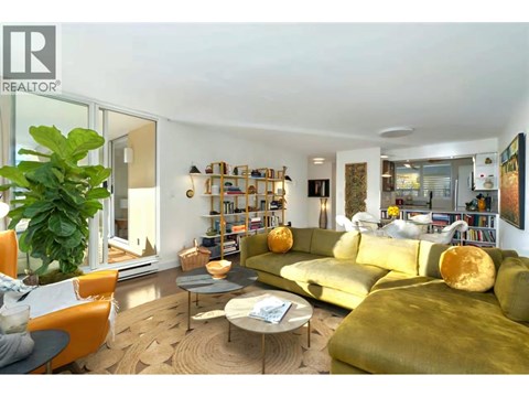 A living room with a green couch and a coffee table.