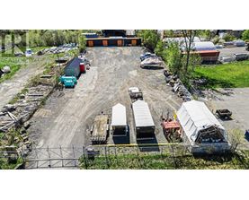 A large outdoor storage area with various containers and trailers.