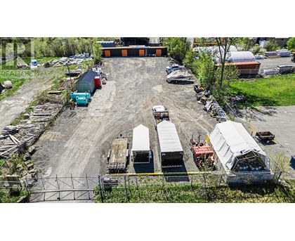A large outdoor storage area with various containers and trailers.