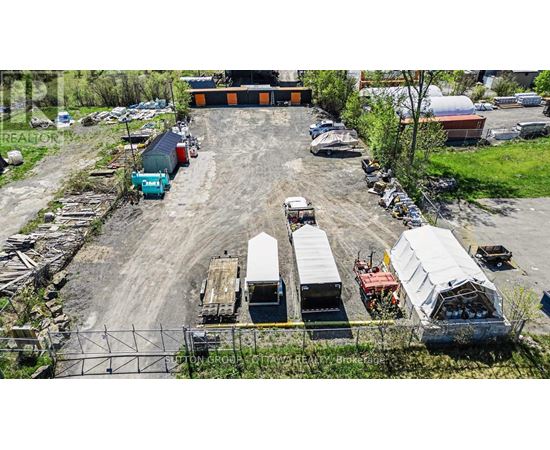A large outdoor storage area with various containers and trailers.