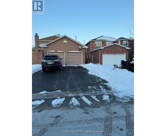 A black SUV is parked in front of a house with a garage.