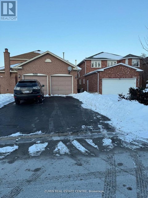 A black SUV is parked in front of a house with a garage.