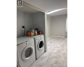 A laundry room with two front loading washing machines.