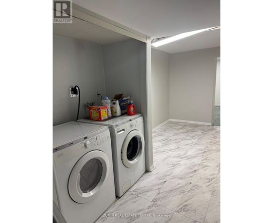 A laundry room with two front loading washing machines.
