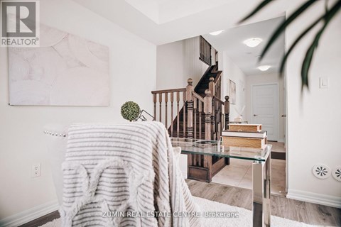 A cozy living room with a couch covered in a white knitted throw.