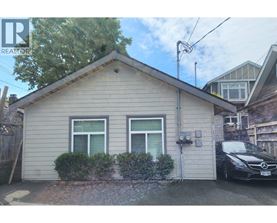 A small house with a car parked in front.