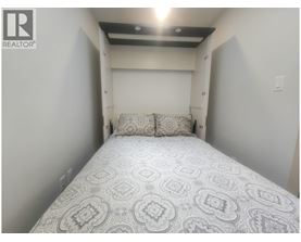 A bedroom with a bed and a pillow.