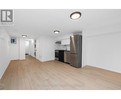 A kitchen area with a refrigerator, oven, and microwave.